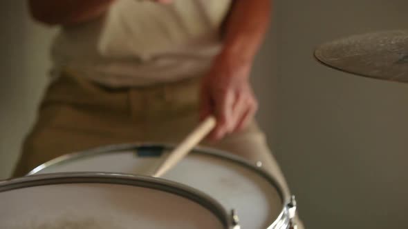 Drummer practicing hit-hat and snare rudiments.
