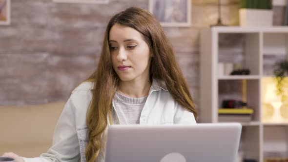 Girl Enjoying a Cup of Coffee While Working From Home