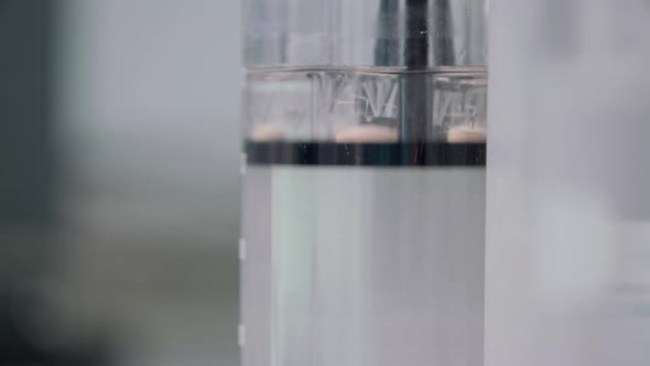 Tablet Thrown Into a Flask of Water and Dissolved