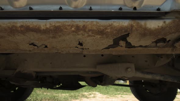 A Closeup of Rotted Rusted Metal in the Fender of a Car