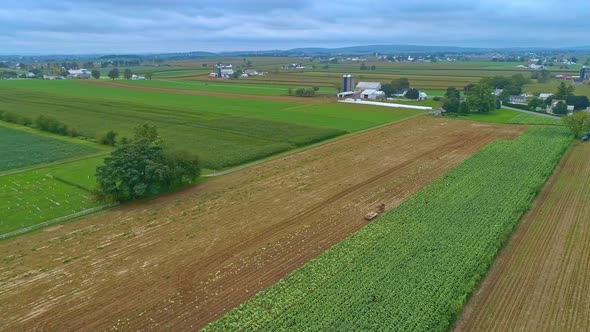 Aerial Traveling View of Corn Fields and Harvesting Crops, with Patches of Color