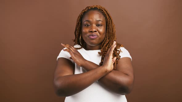 Emotional African American Woman Crossing Hands and Saying No Shaking Head As Denial and Rejection