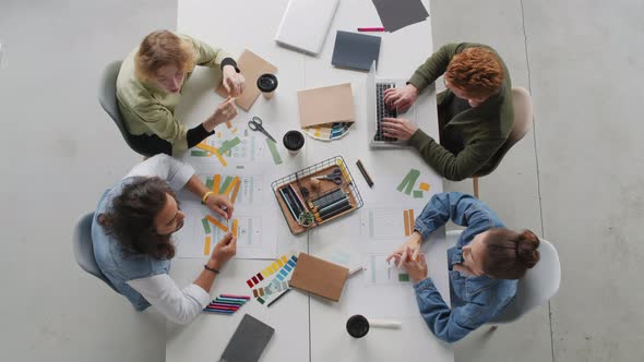 Top View of Team of Young Businesspeople Having Meeting