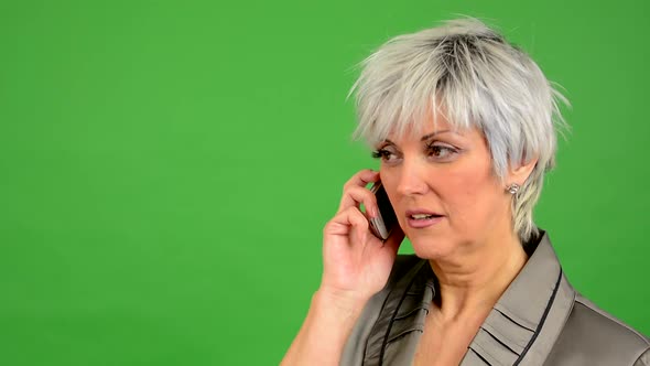 Business Middle Aged Woman Phone and Smiles - Green Screen - Studio - Closeup