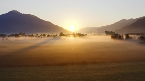 Drone Over Ethereal Misty Landscape Of Zell Am See At Sunrise