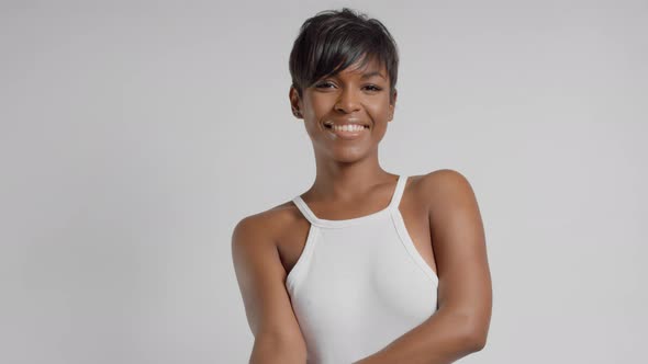 Smiling Mixed Race Woman in Studio with Short Haircut and Soft Skin