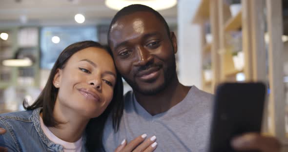 Happy Afroamerican Couple Taking Selfie in Cafe