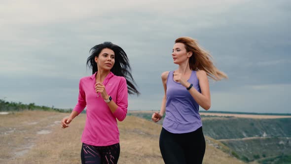 Two Woman Running the Run on the Field