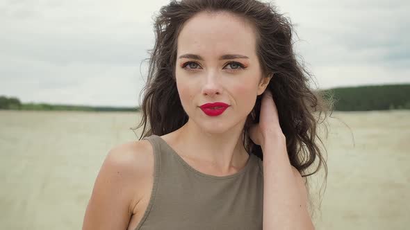 Pretty Woman Touching Hair on Beach