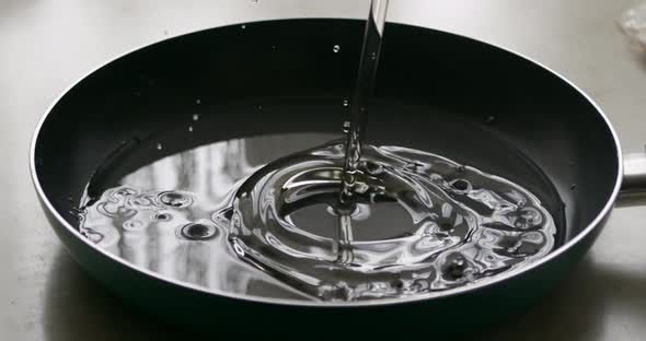 Slow Motion Closeup of Pouring Oil Into a Frying Pan for Cooking