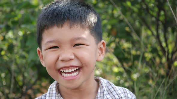 Close up little boy laughing and smile after hearing joke story