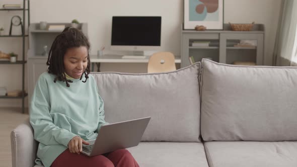 Teenage African Girl Having Video Call Using Laptop