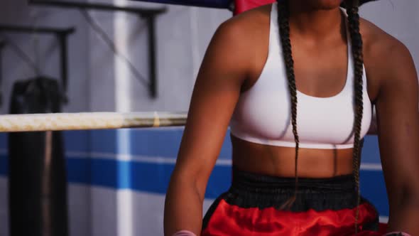 Mixed race woman in boxing ring