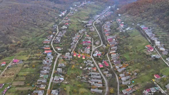 panorama view of village rural area with small houses between autumn