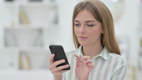 Portrait of Attractive Young Woman Using Smartphone