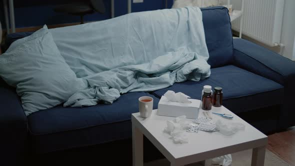 Empty Living Room with Medicine Against Virus Infection on Table