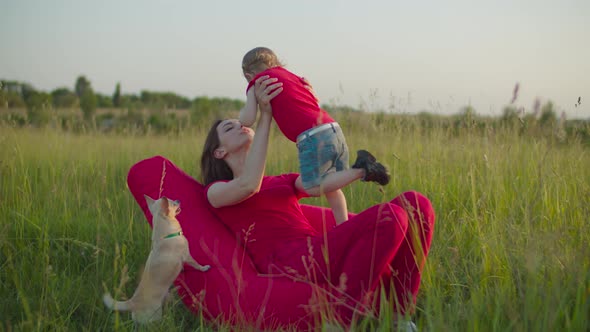 Loving Mother with Child Resting in Summer Nature