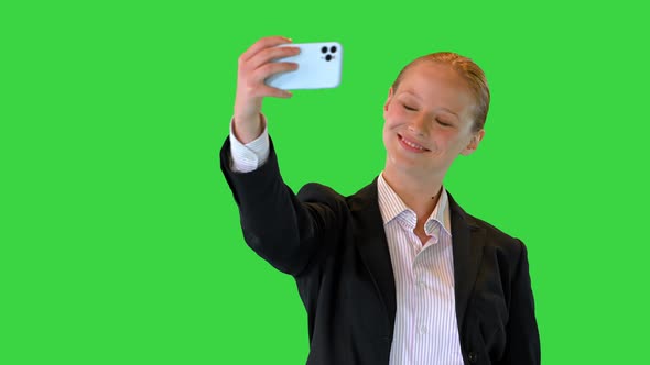 Young Beautiful Business Girl Taking a Selfie on a Green Screen Chroma Key