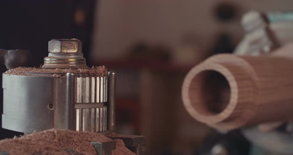 Man working on a wood lathe creating art - slow motion macro shot