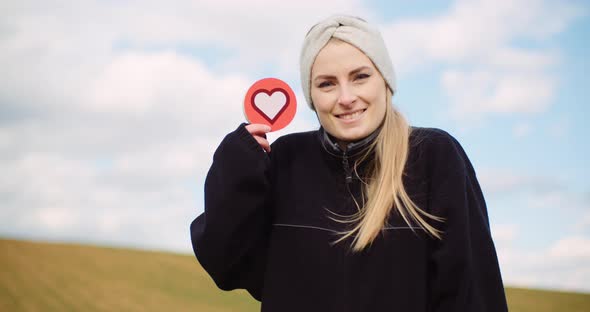 Woman Holding Heart Social Media Icon - Loving Agriculture