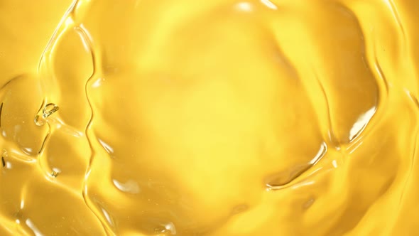 Super Slow Motion Shot of Swirling Golden Oil Liquid at 1000Fps.