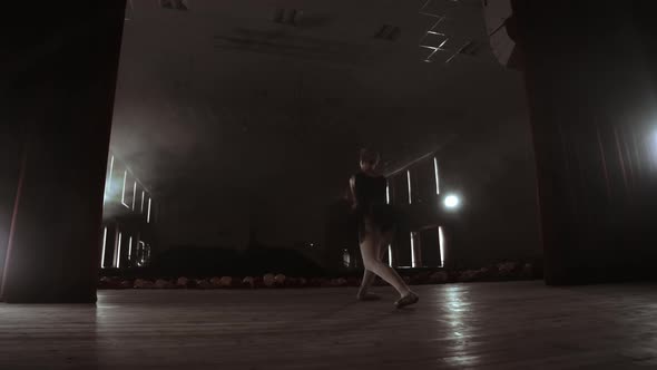 Slow Motion Prima Ballet in a Black Dress Performs Rotations and Dance Graceful Movements Rehearsing