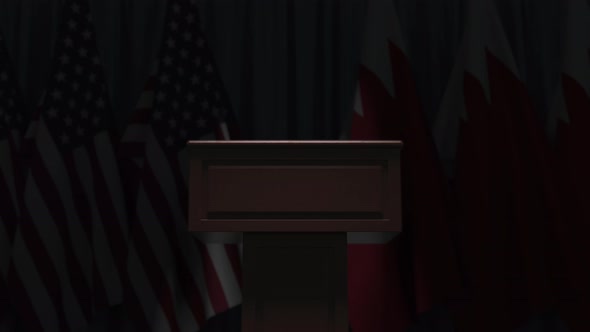 Many Flags of Bahrain and the USA Behind Speaker Tribune alt