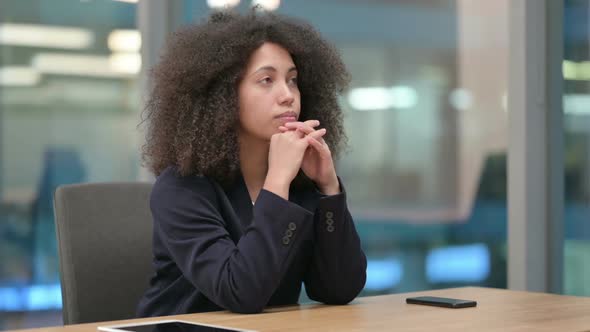 African Businesswoman Sitting in Office and Thinking