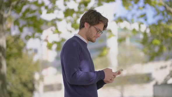 Smiling Man Using Cell Phone Outdoor