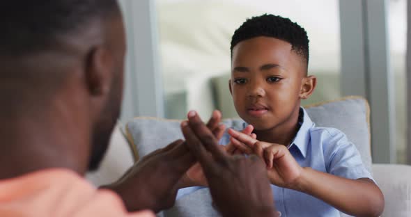 African american father teching his son sign language