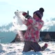 Cheerful Little Girls in Outwear Having Fun and Throwing Snow in Sunlight Standing Outdoors - VideoHive Item for Sale