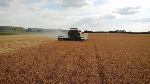 Aerial View Red Harvester Working in the Field