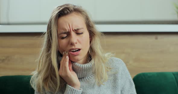 Woman Feeling Strong Pain in Tooth While Staying at Home