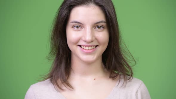 Young Happy Beautiful Woman Smiling Against Green Background