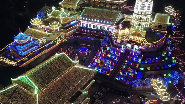 Drone shot with slowly rise up to reveal Kek Lok Si temple in night