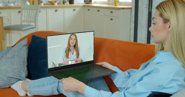 Woman Video Chatting with Doctor. Tele Medicine Check Up From Home on Laptop Over the Internet. Girl