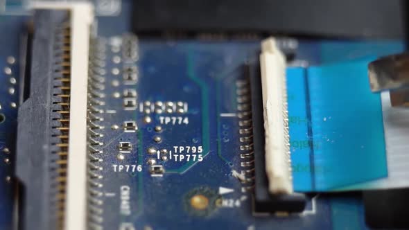 Connecting a Flex Cable to the Laptop Motherboard with Tweezers Laptop Repair in a Service Center