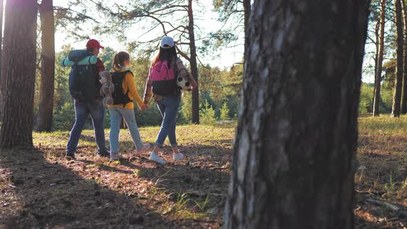 Happy Family Hiking Through a Forest