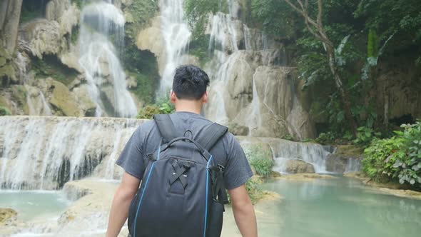 Man Hiking To Waterfall