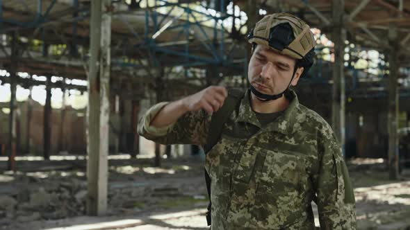 Trained Soldier in Military Uniform Walking on Old Plant