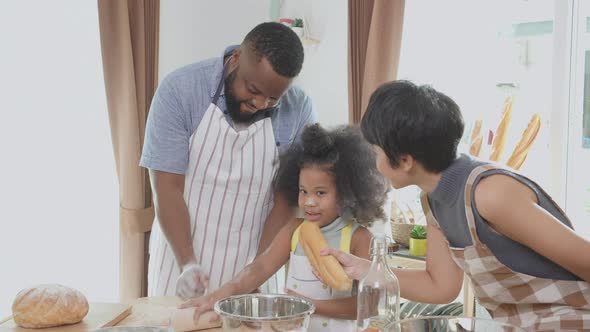 African America family wearing apron thresh flour for cooking and dancing and song together.