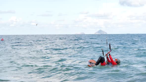 Athlete Showing Sport Trick Jumping with Kite and Board in Air. Extreme Water Sport and Summer