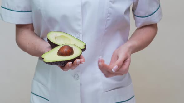 Nutritionist Doctor Healthy Lifestyle Concept - Holding Organic Avocado