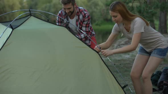 Couple Putting Up Dome Tent, Great Teamwork, Wilderness Survival School, Happy