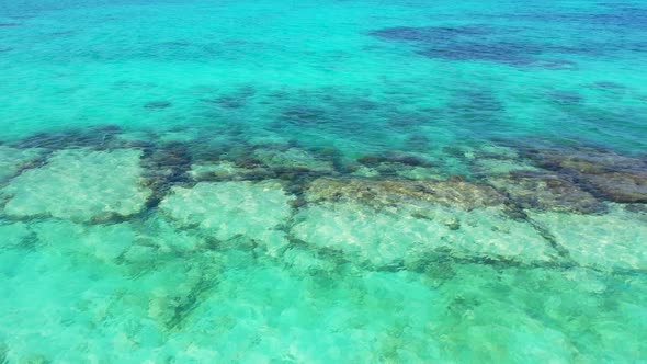 Aerial drone view sky of perfect seashore beach adventure by blue green sea with white sandy backgro