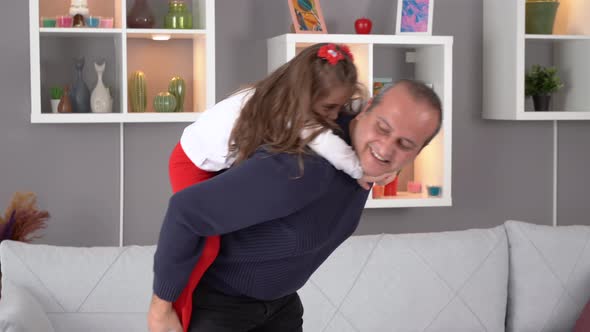 Father playing with his little daughter at home.