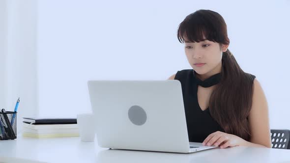 Beautiful freelance young asian woman smile and happy working online laptop computer success.