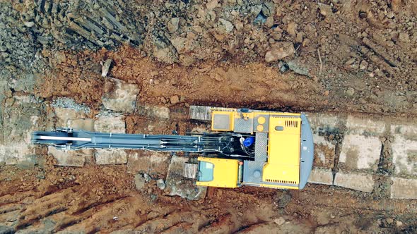 Excavator is Riding Across the Digging Site