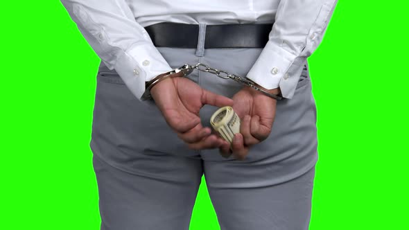 Businessman in Handcuffs Holds Money