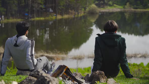 Campfire and two friends chatting.